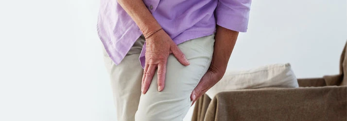 A woman holding her leg with sciatic pain