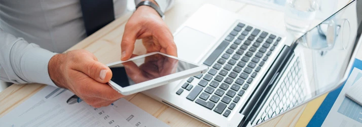 An office worker using a tablet at his desk