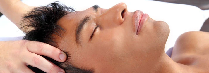 A man receiving a head massage