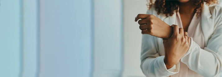 A woman holding her wrist.