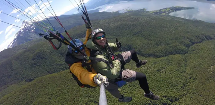 Elliot Lysyk paragliding with a mountain in the background.