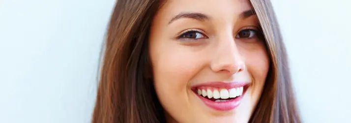 A brunette woman smiling.