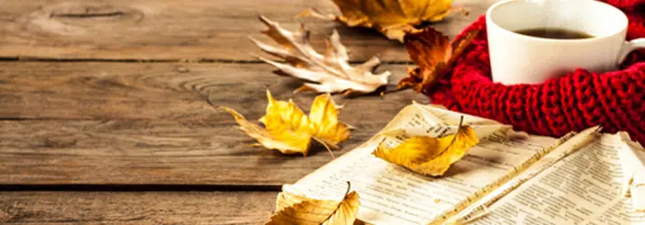 A cup of tea, surrounded by leaves.