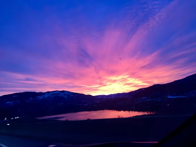 A sunset over a tranquil lake