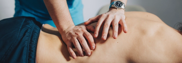A massage therapists hands while performing deep tissue massage
