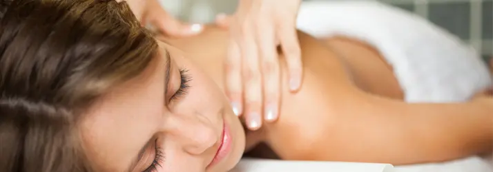 A relaxed woman with eyes closed during a massage