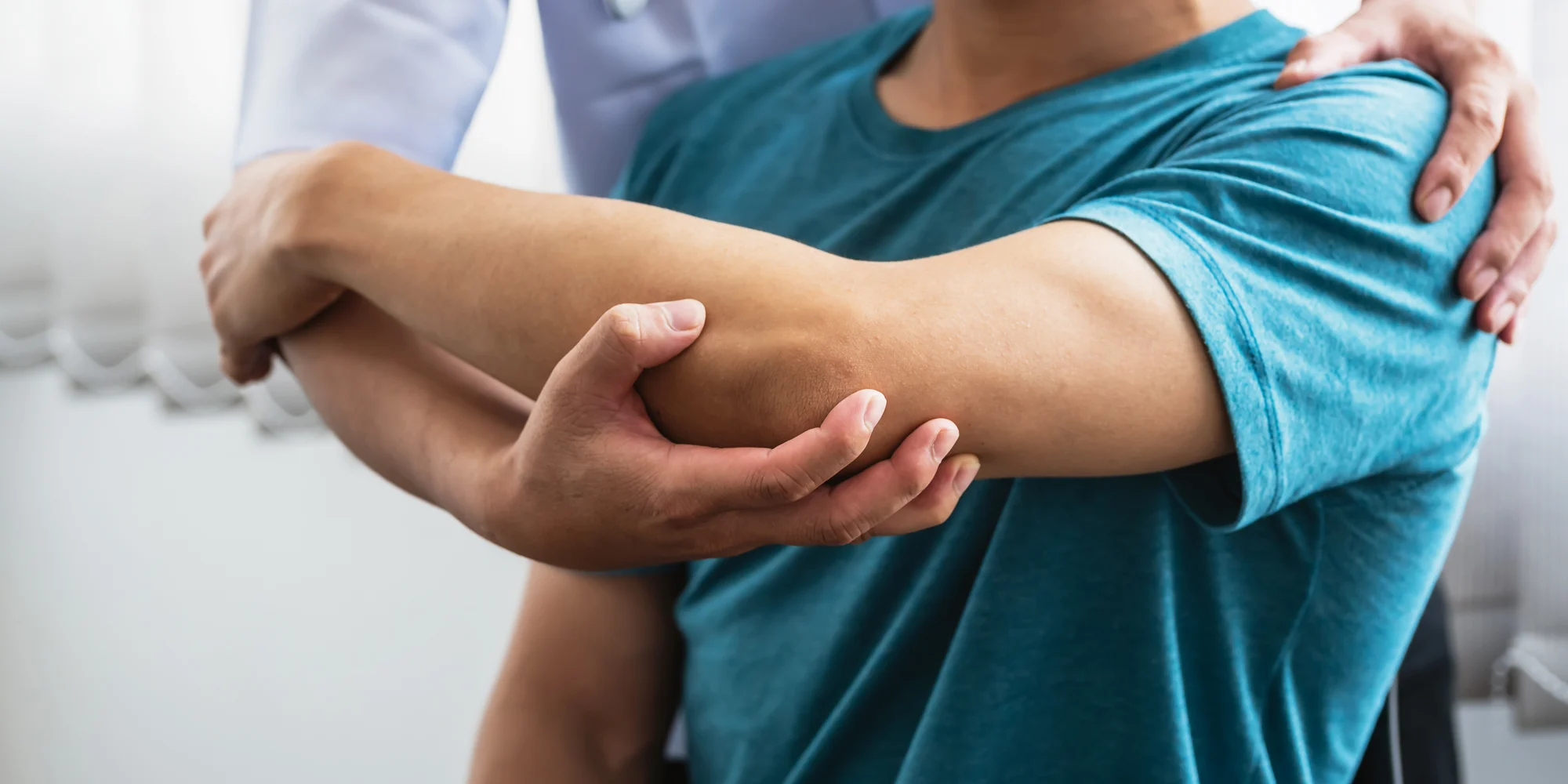 A physiotherapist assisting a patient in stretching their arm