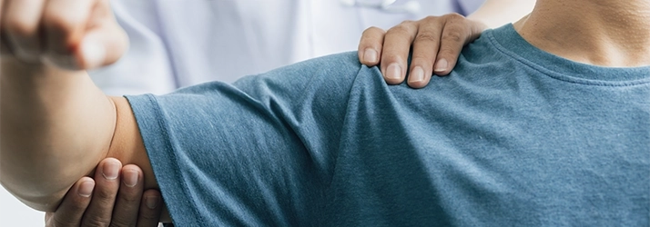 A physiotherapist examining the movement of a patient's arm