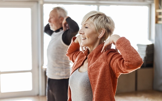 Two elder patients stretching and doing aerobic exercise
